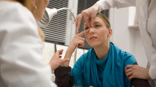 Woman in a doctor's office getting nose evaluated