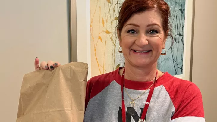 Shira Suggs holding bagged breakfast