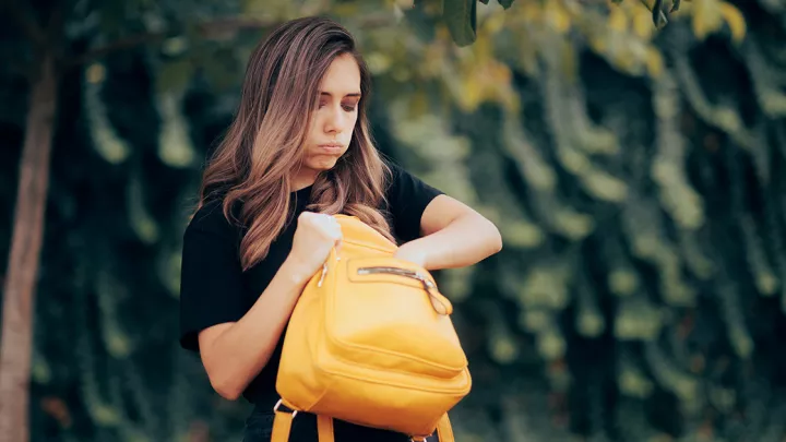 picture of a woman looking in her purse