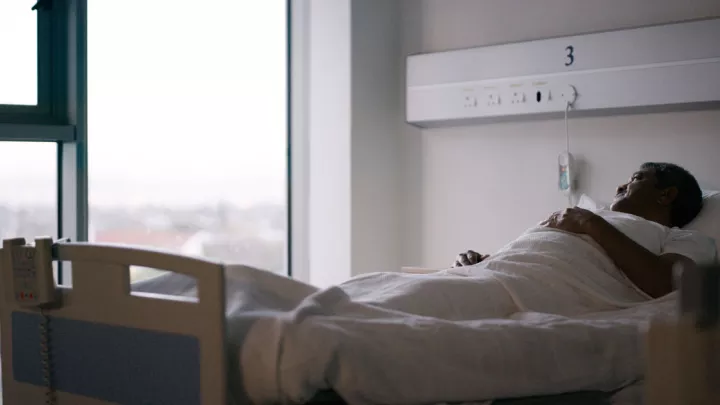Elderly man in hospital bed