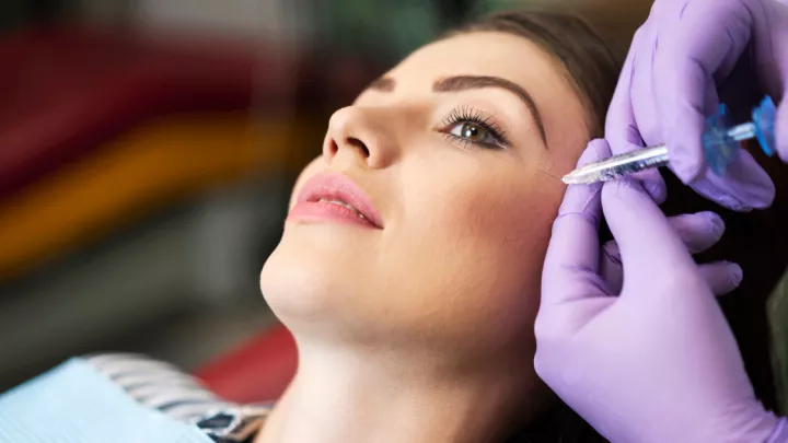 Woman receiving cheek filler