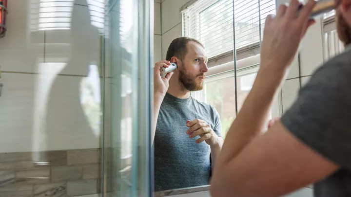 Man trimming his ear hair