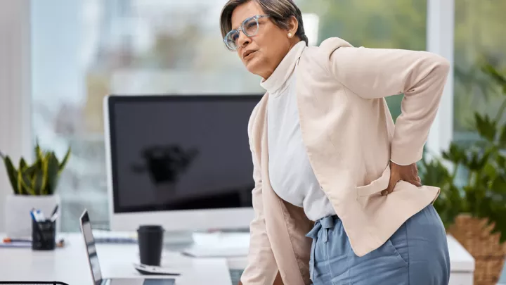 Woman holding her lower back in pain