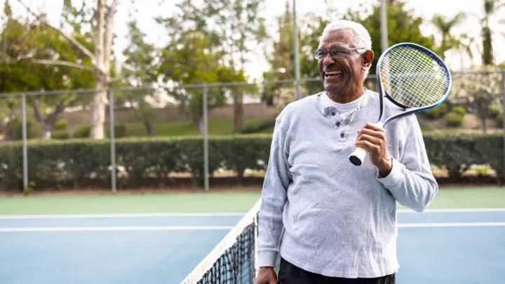 An older man playing tennis