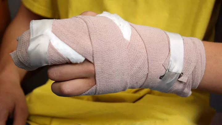 Close up of a hand wrapped in gauze