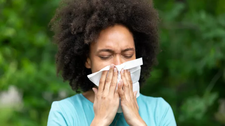 Woman blowing her nose