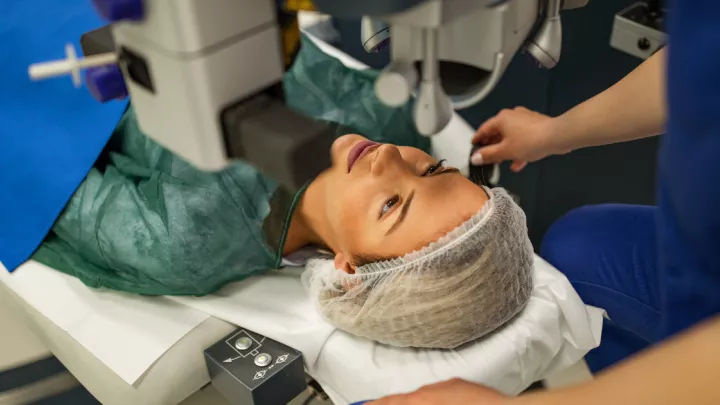 A picture of a woman getting laser eye surgery