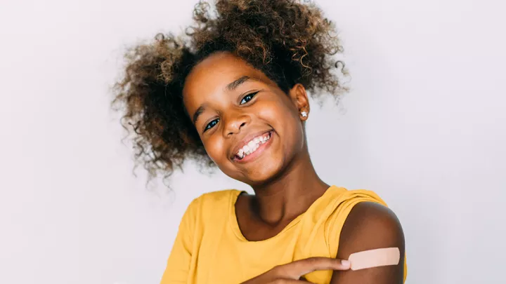 picture of a young girl with a bandaid on her arm