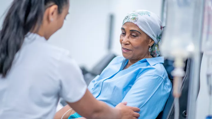 Older woman receiving chemotherapy treatment