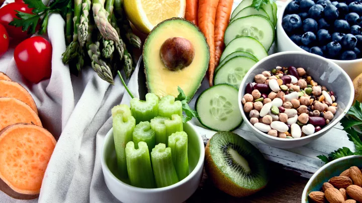 Table with various fruits, vegetables, and nuts