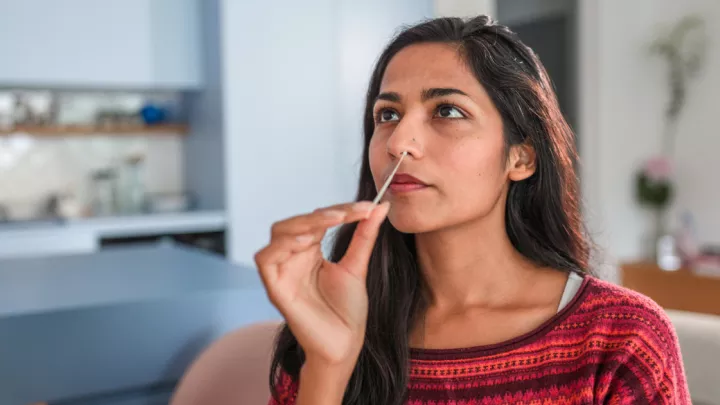 Woman swabbing her nose