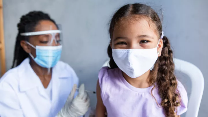 Two women masked - one child, one adult
