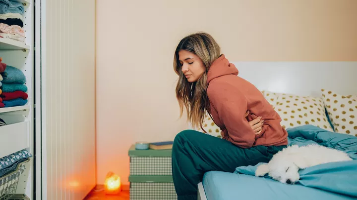 picture of a woman sitting on her bed