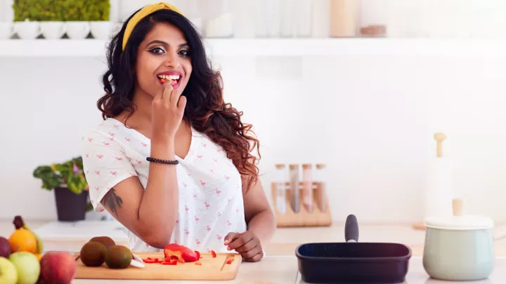 Woman cutting fruits and vegetables