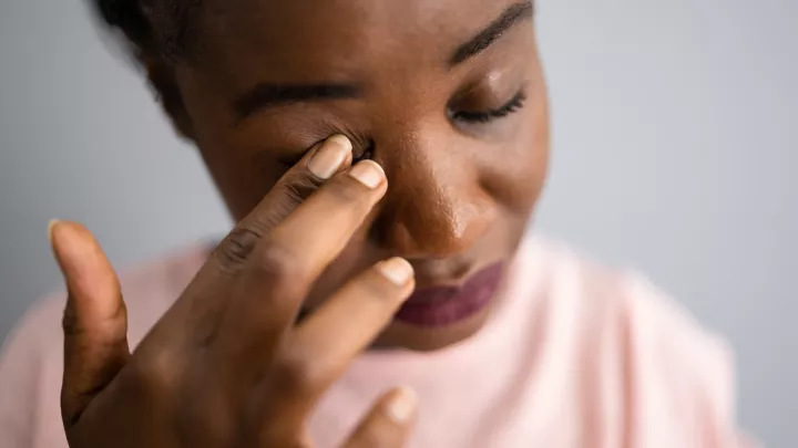 Girl rubbing her eye
