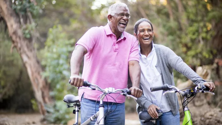 picture of a man and woman biking outdoors