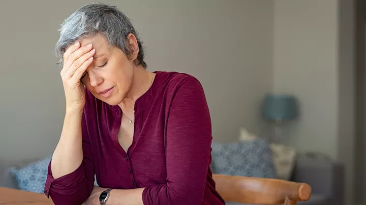 picture of a woman struggling with a headache