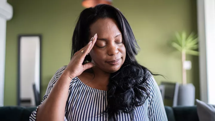 Woman holding her head in pain