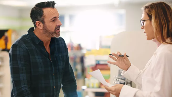 man talking to a pharmacist