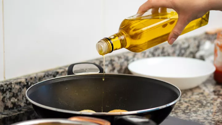 Pouring oil in a pan