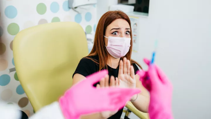 Woman in a clinic scared of needle 