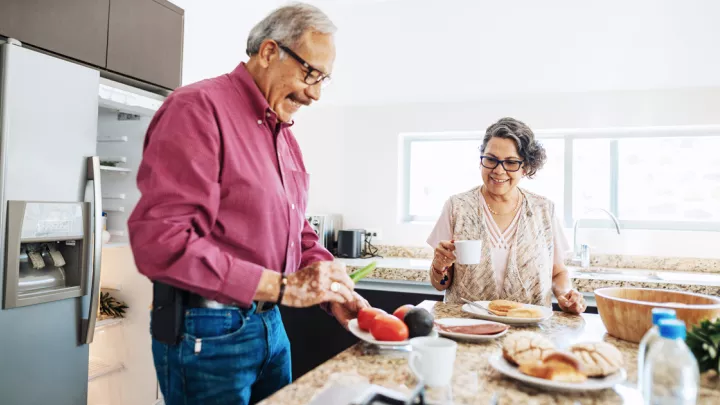 Man and woman making a meal in the kitchen