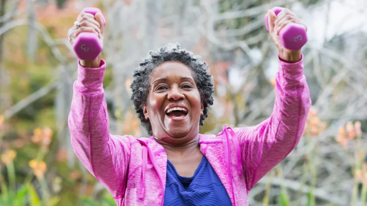 Older woman lifting hand weights