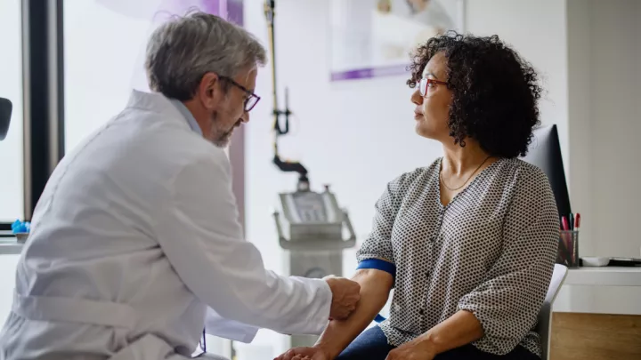 Woman getting her blood drawn by her doctor