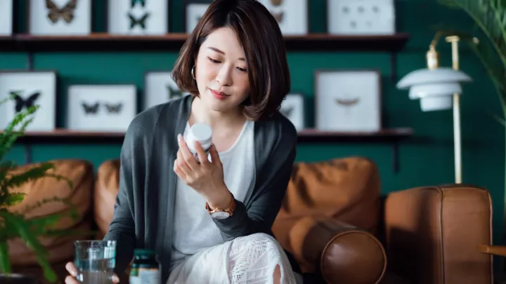 Woman reading a pill bottle