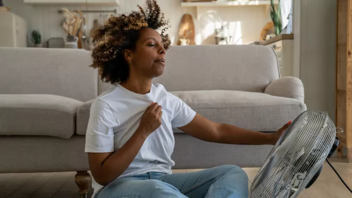 Woman sitting in front of a fan