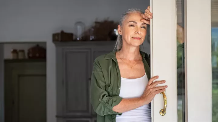 picture of a woman looking out a door