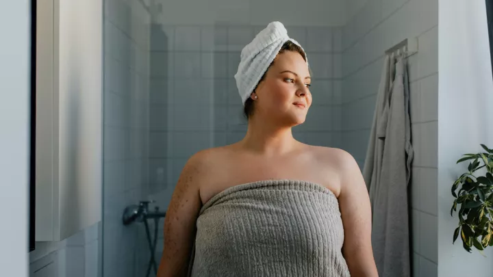 Woman wrapped in a towel coming out of the shower